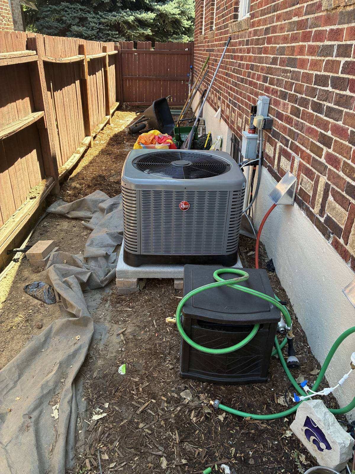 AC replacement: Rheem air conditioner condenser installed beside a Colorado home