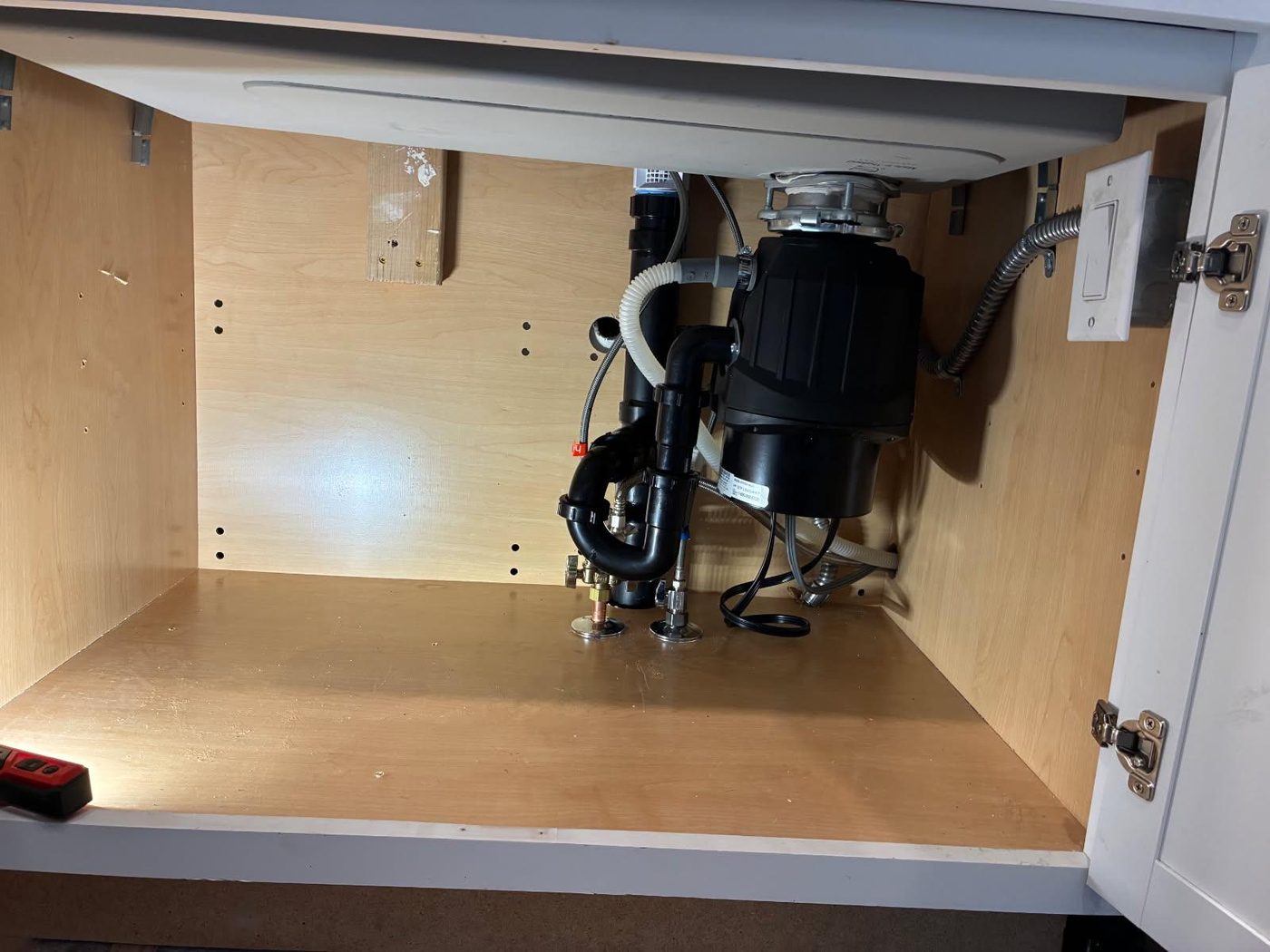 Plumbing repair: garbage disposal and P-trap installation under a kitchen sink in Lone Tree, CO